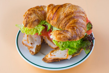 Sandwich of croissant of lettuce, tomato and smoked turkey