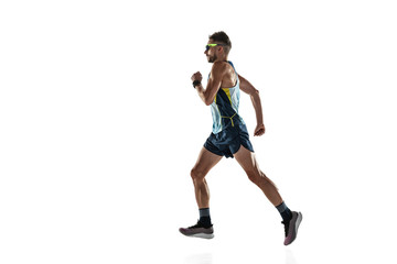 Triathlon male athlete running isolated on white studio background. Caucasian fit jogger,...