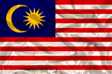 beautiful photo of the national flag of Malaysia on delicate shiny silk with soft draperies, the concept of state power, country life, horizontal, close-up, copy space