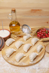 Dumplings on a wooden board with cherry