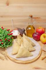 Crepes on a wooden board with apples