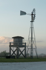 Naklejka premium Windmill at the nature Conservatory Twin Oaks Park located at Osceola County in Central Florida