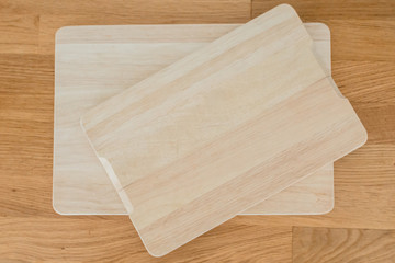 Kitchen wooden boards for cutting rye, vegetables, fruits, meat on the table. Wooden background
