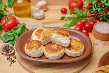 Cheesecakes on a wooden board with cottage cheese