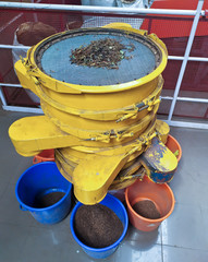 Tea leaves factory sorting machines. Different colored boxes with black tea at the tea factory.