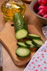 Cooking a salad of fresh cucumbers and radishes