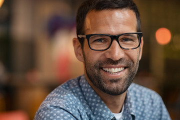 Portrait of smiling man looking at camera - Powered by Adobe