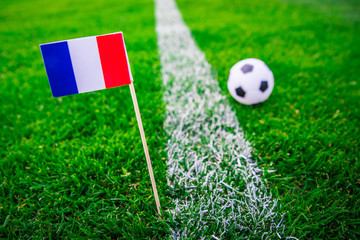 France national Flag and football ball on green grass. Fans, support photo, edit space