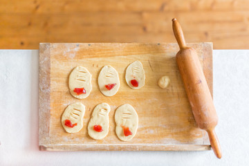 Preparation of homemade sweet cakes filled with jam from rolled out yeast dough