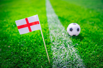 England national Flag and football ball on green grass. Fans, support photo, edit space