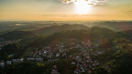 Fototapeta premium Aerial view of downtown Tuzla at sunset, Bosnia. City photographed by drone, traffic and objects , landscape.city photographed from air by drone.Old balkan buildings and communism type of architecture