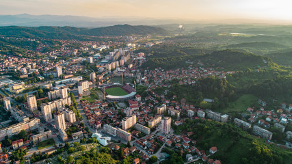 Aerial view of downtown Tuzla at sunset, Bosnia. City photographed by drone, traffic and objects , landscape.city photographed from air by drone.Old balkan buildings and communism type of architecture