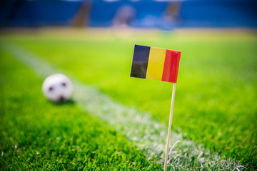 Obraz premium Belgium national Flag and football ball on green grass. Fans, support photo, edit space