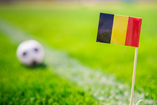 Belgium national Flag and football ball on green grass. Fans, support photo, edit space
