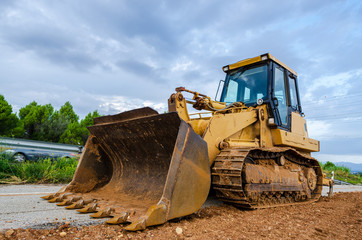 Obraz na płótnie Canvas Yellow Construction bulldozer at Work
