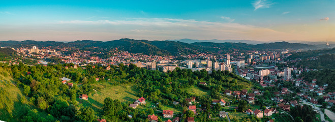 Aerial view of downtown Tuzla at sunset, Bosnia. City photographed by drone, traffic and objects , landscape.city photographed from air by drone.Old balkan buildings and communism type of architecture
