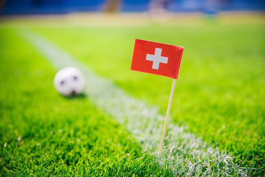 Switzerland national Flag and football ball on green grass. Fans, support photo, edit space