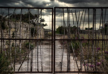 Gate locked with padlock at abandoned factory