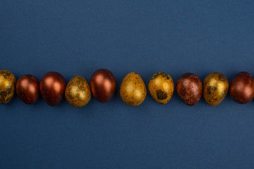 Golden easter eggs on blue