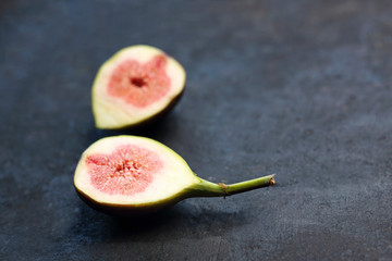 Fig, a sweet exotic fruit on a dark background.