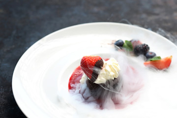 Dessert frozen with liquid nitrogen. Appetizing dessert with whipped cream.