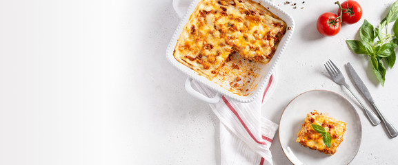 Italian restaurant banner. Lasagna with vegetables, minced meat, cheese bolognese and bechamel sauce. Top view, menu, recipe. Copy space - obrazy, fototapety, plakaty