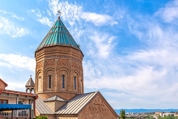 Fototapeta na wymiar Dome of the 13th-century Armenian Church of St. George, against the blue sky, in Tbilisi