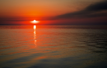 Obraz premium Beautiful colorful sunset on the sea coast. Nice scene with sunrise over water