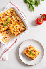 Delicious Homemade Italian Lasagna with bolognese and bachamel Sauce on white Background. Hot Tasty Lasagna with Parmesan Cheese. Restaurant menu, recipe