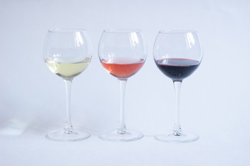 White, pink, red wine in glasses on white background isolated