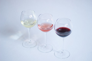 White, pink, red wine in glasses on white background isolated