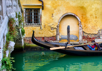 Fototapeta na wymiar Gondola Moored in a Canal in Venice