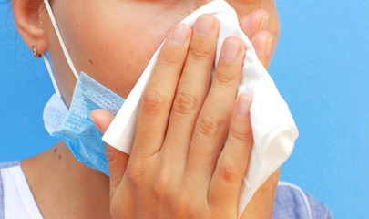 COVID-19 virus epidemic, woman blowing her nose