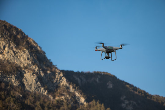 drone in flight over mountains in a sunny day