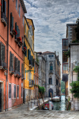 Fototapeta na wymiar Gondola Moored in a Canal in Venice