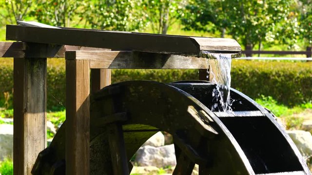 a spinning water wheel with flowing water