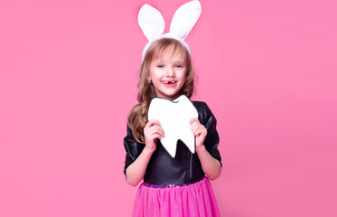 Happy Easter! Funny girl kid child in the form of an Easter Bunny with a human tooth layout. Baby...