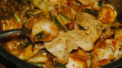 Close-up of Pecel - Traditional Javanese salad, consisting of mixed vegetables in a peanut sauce dressing, served with omelet.
