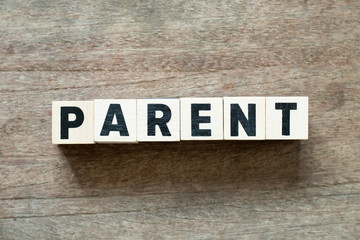 Letter block in word parent on wood background