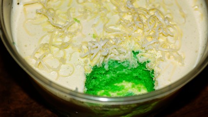 Close up Pandan leaf cheesecake on wooden background. Selective focus depth of field. (image contain certain grain or noise and soft focus when view at full resolution).