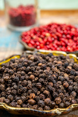 Bowl with dried black and red round peppers condiment