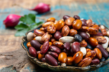 Colorful dried different types of beans legumes in bowl