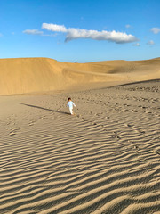 Toddler walking around the Dunes of Maspalomas, in Gran Canaria Island
