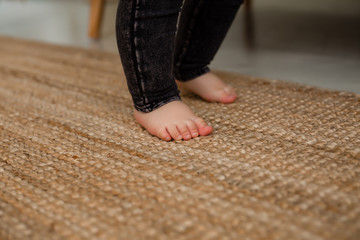 children's feet on the carpet of natural materials. eco-friendly home products