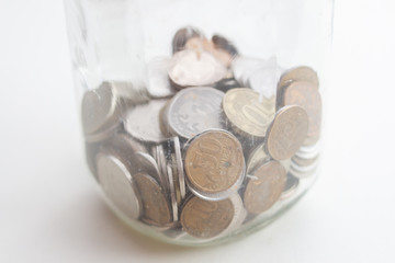 coins in a glass jar close up