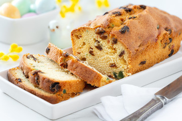 Delicious traditional fruitcake with raisins and candied fruit. Sliced plumcake with glaced fruit