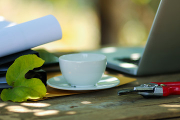 Laptop on wood table for working online at home in the garden.