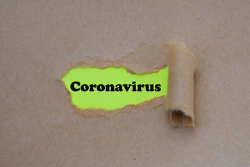 coronavirus word written under torn paper. concept.