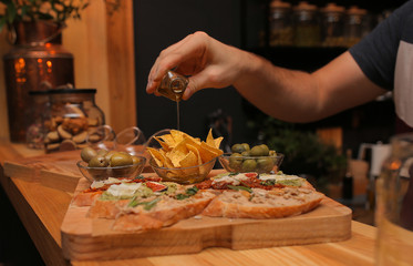 sandwiches on a wooden tray with chips