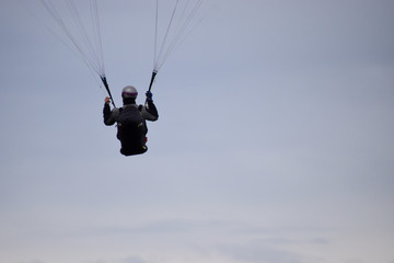 Success concept. A man paragliding in a clear sky